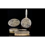 A Danish White Metal Vanity Set four items in total to include hand mirror, trinket box, hair