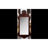 A Reproduction Georgian Style Bevelled Glass Mirror In shaped Mahogany finish frame. 20 x 43.