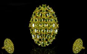 Peridot Oval Cluster Ring, a cluster of oval and round cut peridots totalling over 6cts,