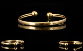 9ct Gold Torque Bangle Of plain form, fully hallmarked, 8.9 grams total weight.