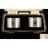 A Boxed Pair of Fine Quality Silver Napkin Holders, Engine Turned with Vacant Cartouches.