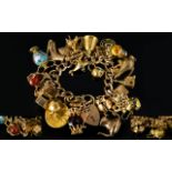 Superb Quality 9ct Gold Curb Bracelet Loaded with 28 9ct Gold Charms.