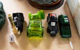 A Collection Of Four Novelty Avon Scent Bottles Each modelled in the form of a vehicle. To include