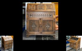 Oak Panelled Bureau of small proportions and typical form. Fall front with carved panel detail.