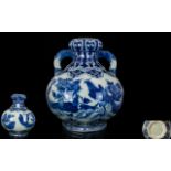 A 20th Century Blue And White Twin Handle Onion Topped Vase Blue and white decoration depicting