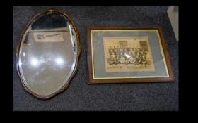 Antique Mirror Oval bevelled glass mirror in undulating frame with chain hanging detail to back,