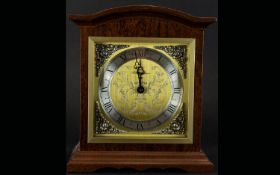 A Modern Reproduction Mantle Clock Wooden cased with etched and brushed gold tone face and silver