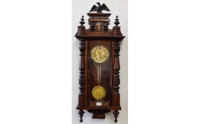 Vienna Wall Clock typical form, spring driven movement with pendulum. Mahogany veneered case,