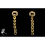 A Pair Of 18ct Gold And Diamond Set Drop Earrings Of stylised form with post and stud fastening.