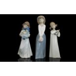 Lladro And Nao Porcelain Figures. Three Figures In Total (1) Little Girl With Rag Doll.