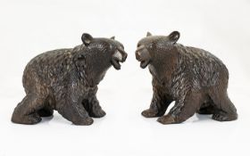 A Pair Of Black Forest Style Carved Bears Two black bears in prowling stance with glass eyes, each