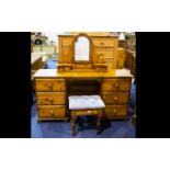A Pine Dressing Table comprising two banks of three drawers complete with swivel mirror and stool.