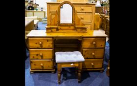 A Pine Dressing Table comprising two banks of three drawers complete with swivel mirror and stool.