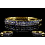 Tanzanite Double Row Hinged Bangle, two rows of oval cut tanzanites, totalling 9cts,