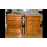 A Pair Of Miniature Chests Of Drawers In beech wood, each with four drawers,