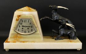 Art Deco Figure Group Mantle Clock Raised on two tone rectangular base of cream striated marble