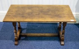 An Oak Coffee Table By Bath Easton And Chingford Of typical rustic form with turned supports.