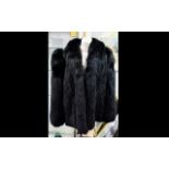 Black Fox Fur Jacket. Hip length style. Fully lined in black polysilk fabric. Size 12.