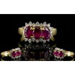 18ct Gold Ruby And Diamond Cluster Ring With three central oval cut rubies,