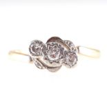 A diamond three stone crossover ring,