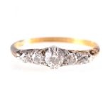 A diamond five stone ring, the old cut stones graduating in size,