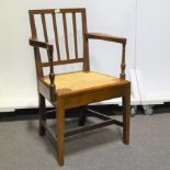 Victorian oak elbow chair, rush seat, width 56cm.