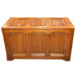 Gothic revival oak coffer, hinged and panelled lid, sides and front, all with carved linen fold,