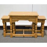 Nest of three solid oak occasional tables, the larger with rectangular top, carved spandrels,