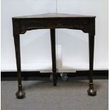 19th Century carved oak corner table, rounded triangular top, carved frieze, corbels,