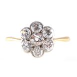 A diamond circular cluster ring, seven old brilliant cut diamonds,