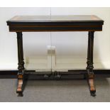 Victorian amboyna and ebonised games table, rectangular fold-over top, turned columns,