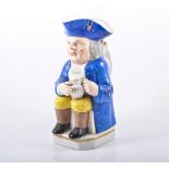 Staffordshire porcelaneous Toby Jug, late 19th Century, Mr Toby seated holding a foaming jug of ale,