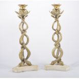 Pair of brass candlesticks, drip pan supported by open work serpent columns,