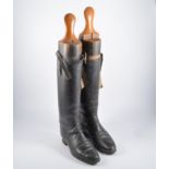 Pair of old leather riding boots, with wooden trees.