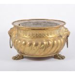 Pair of continental brass jardinieres, gadrooned bodies, with lion ring masks, paw feet, width 29cm.