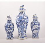 Pair of Chinese blue and white baluster shape vases, domed lids, bearing four character marks,