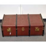 A burgundy hard bodied trunk with metal banding and leather handle to each end, 92cm x 48cm,