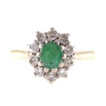 An emerald and diamond oval cluster ring,