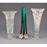 Five crystal vases and a slender green glass vase.