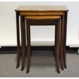 Nest of three Edwardian mahogany occasional tables, each with a serpentine top, satinwood stringing,