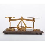 Set of Victorian style brass postal balance scales, wooden platform with weights, width 22cm.