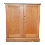 Oak cupboard, rectangular top, two panelled doors, plinth base, width 97cm, depth 37cm,