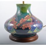 A Moorcroft Table Lamp, "Finches" design by Sally Tuffin for Moorcroft on a green ground, 28cm high,