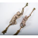 Two lead glazed pottery models of monkeys climbing ropes - one much restored.