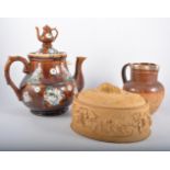 Treacle glazed Barge ware teapot; Doulton Lambeth stoneware jug with a silver collar; stoneware mug,