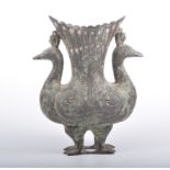 Islamic style cast metal peacock vase, formed as two bird standing tail-to-tail,