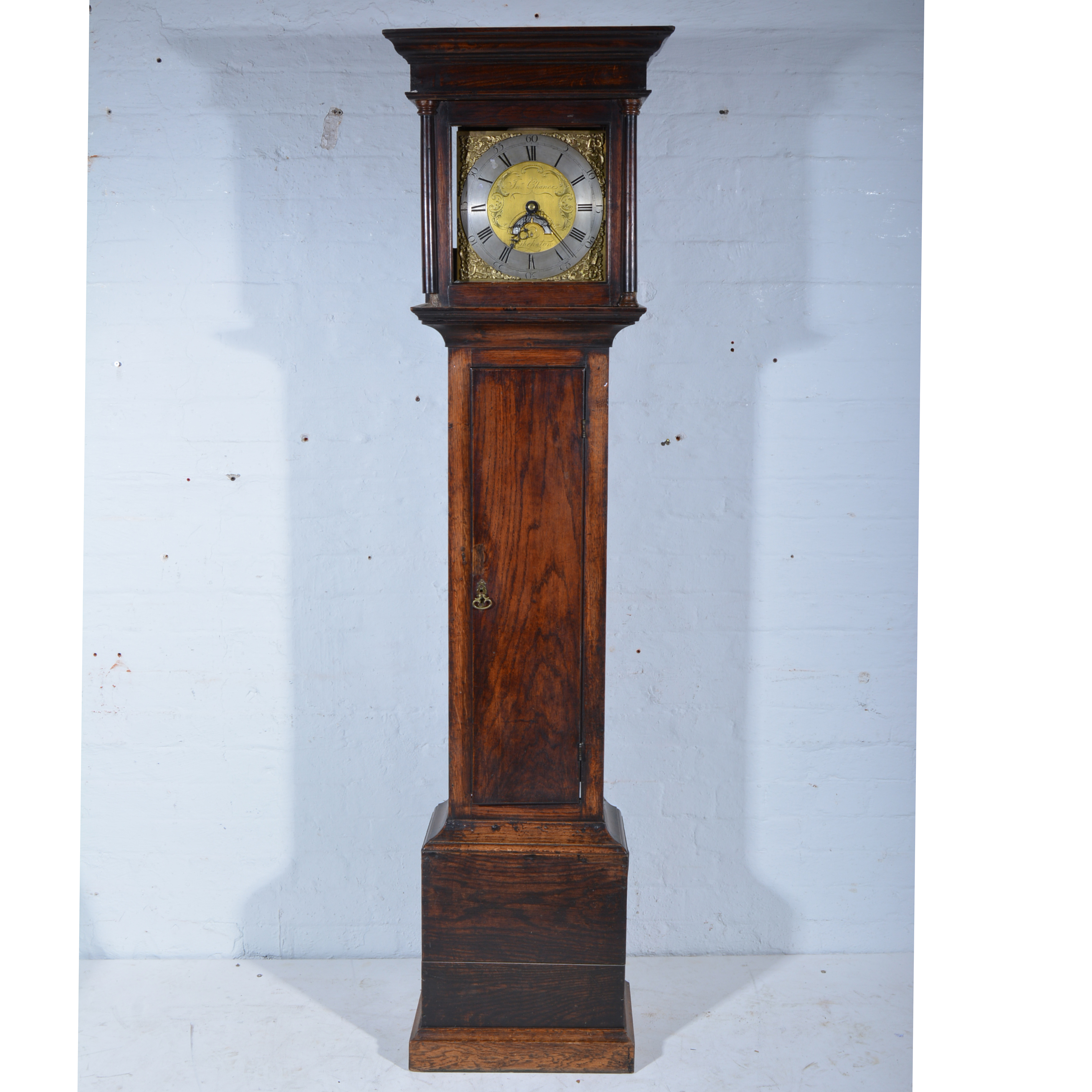 Oak longcase clock, moulded cornice, plain frieze, the hood with three-quarter turned columns,