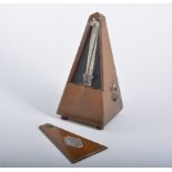 A Maelzel Paquet metronome, set of cast iron scales with brass pans and seven weights,