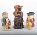 Staffordshire treacle glazed Toby jug, 25cm and a collection of Toby jugs,