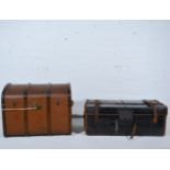 A leather bound travelling trunk and a domed cabin trunk,